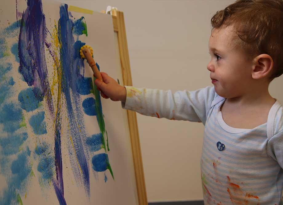 Niño con manos pintadas